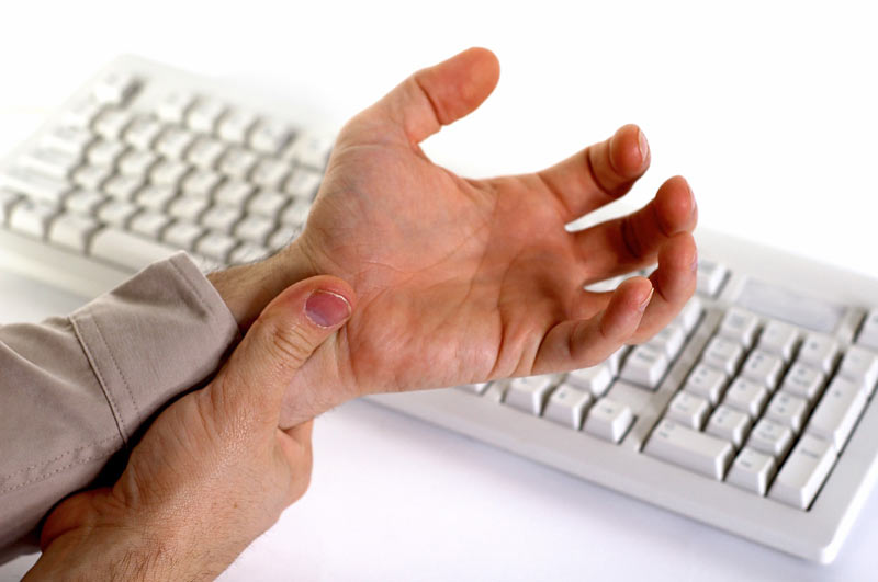 Wrist pain caused by carpal tunnel syndrome Person holding wrist affected by carpal tunnel syndrome